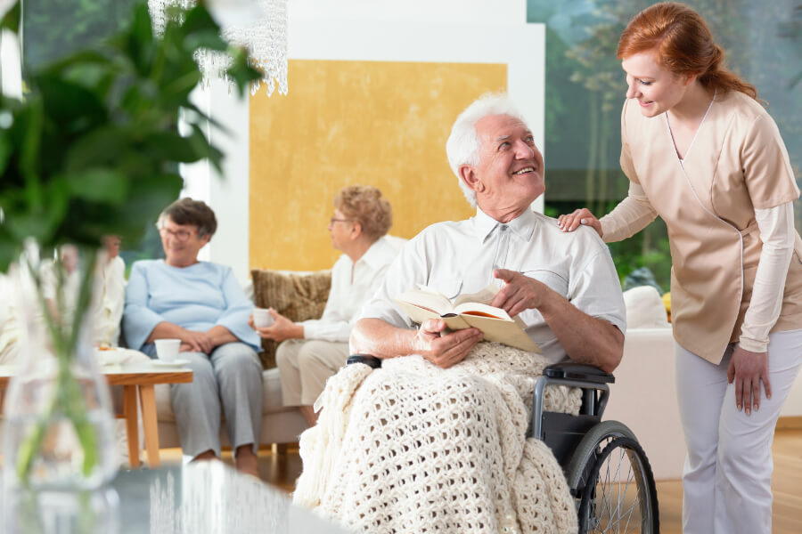 happy-paralyzed-senior-man-in-a-wheelchair-reading-U6LJTPE.jpg